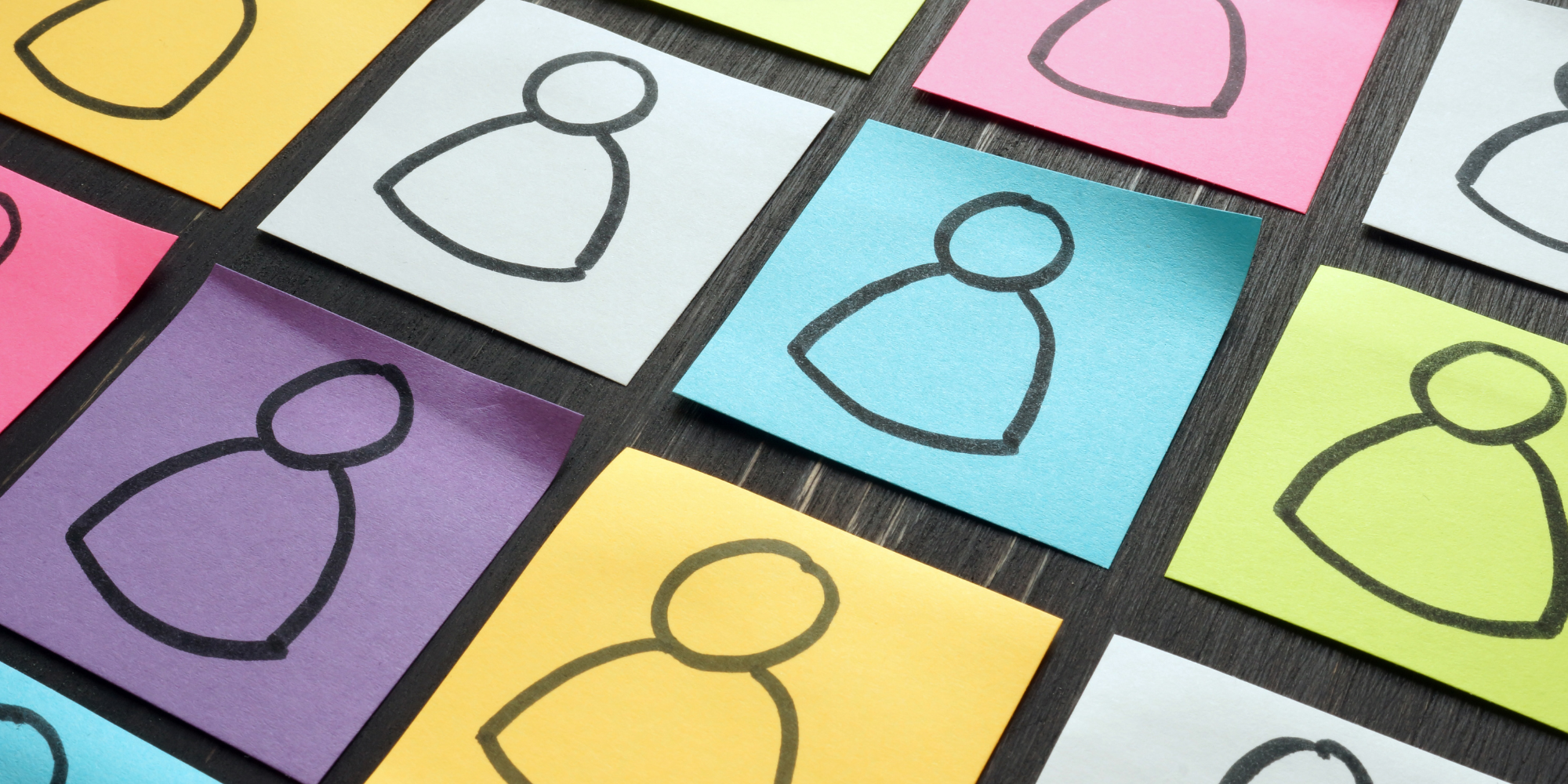 Different colored sticky notes with stick figures