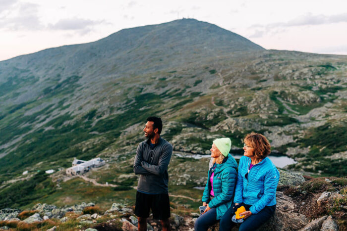 Appalachian Mountain Club three people on top of a mountain