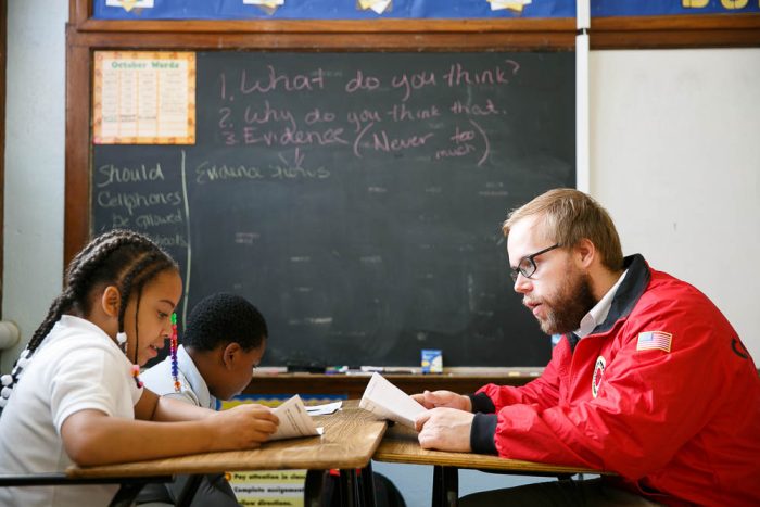 City year volunteer working with a student