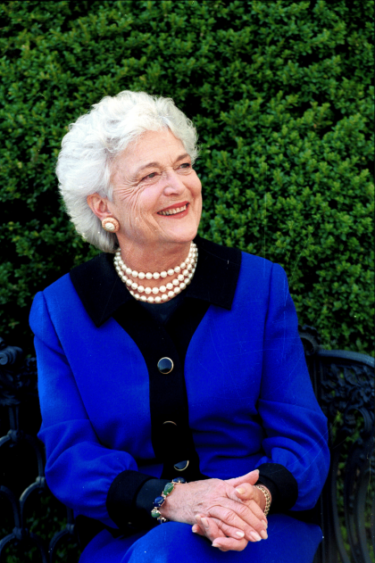 Barbara Bush smiling on a bench