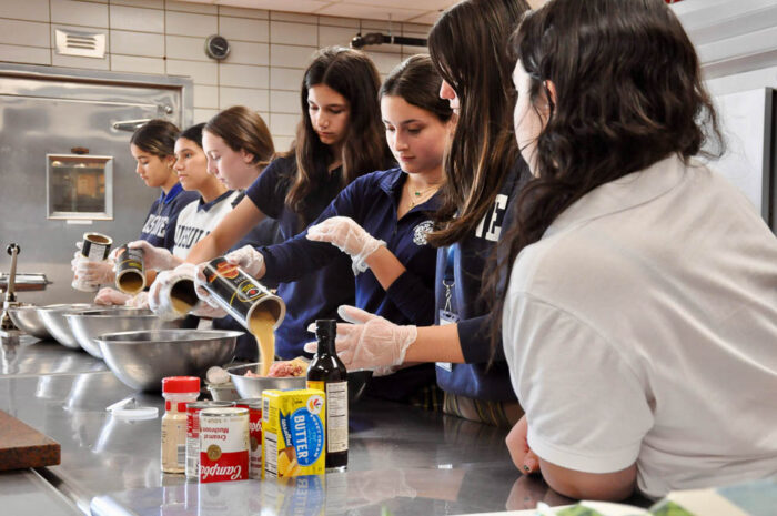 Ursuline School students working in a kitchen