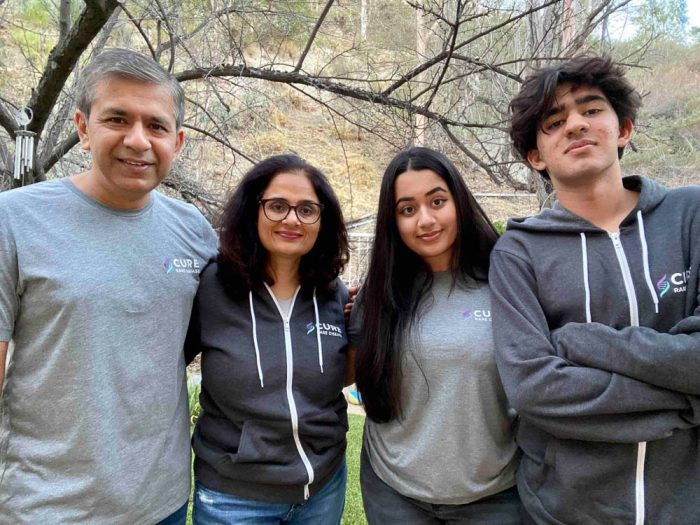 family of four wearing cure rare disease sweatshirts 